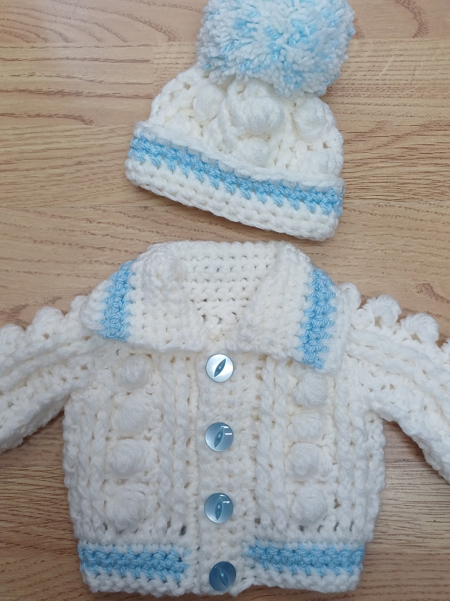 Babys handmade crocheted cardigan and pom hat set