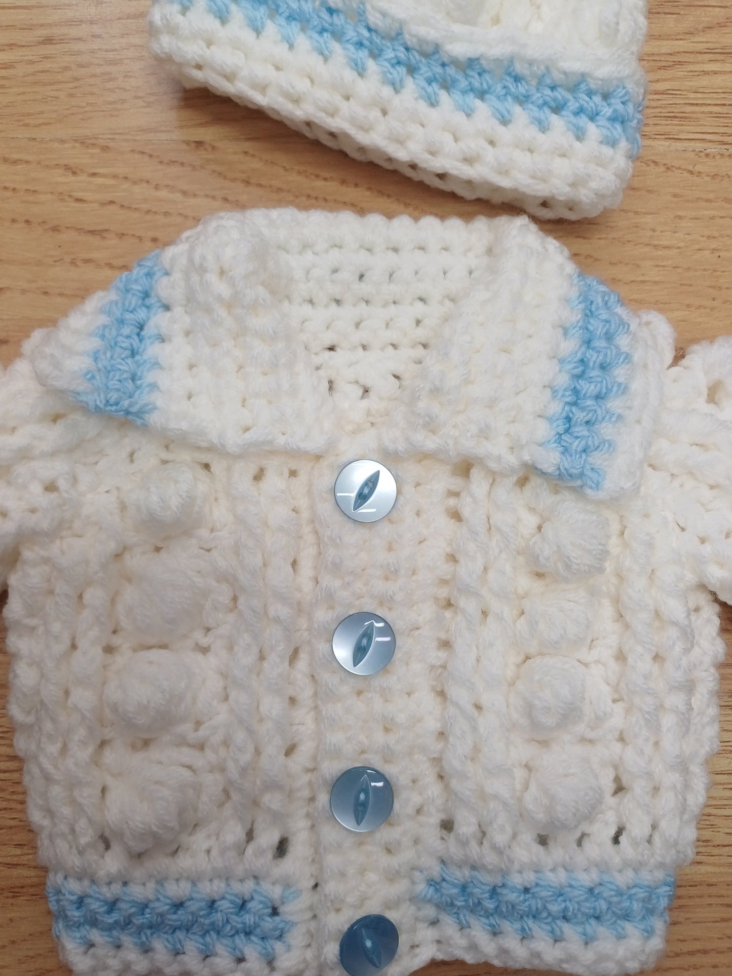 Babys handmade crocheted cardigan and pom hat set