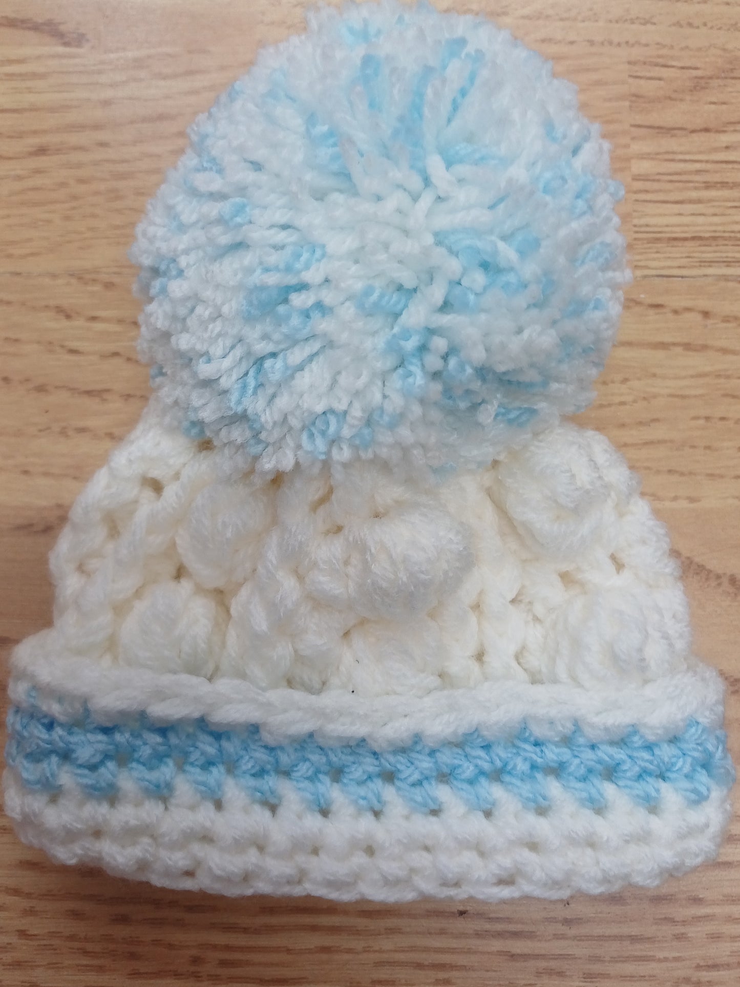 Babys handmade crocheted cardigan and pom hat set