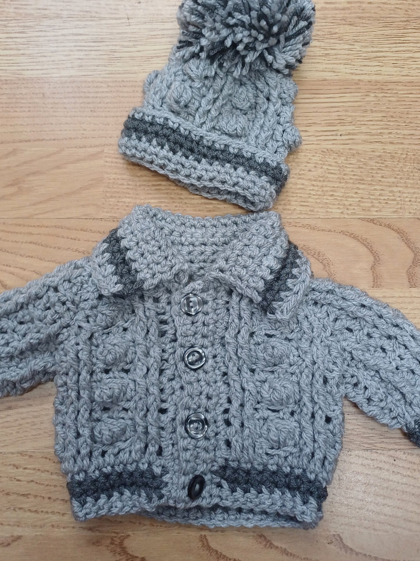 Babys handmade crocheted cardigan and pom hat set