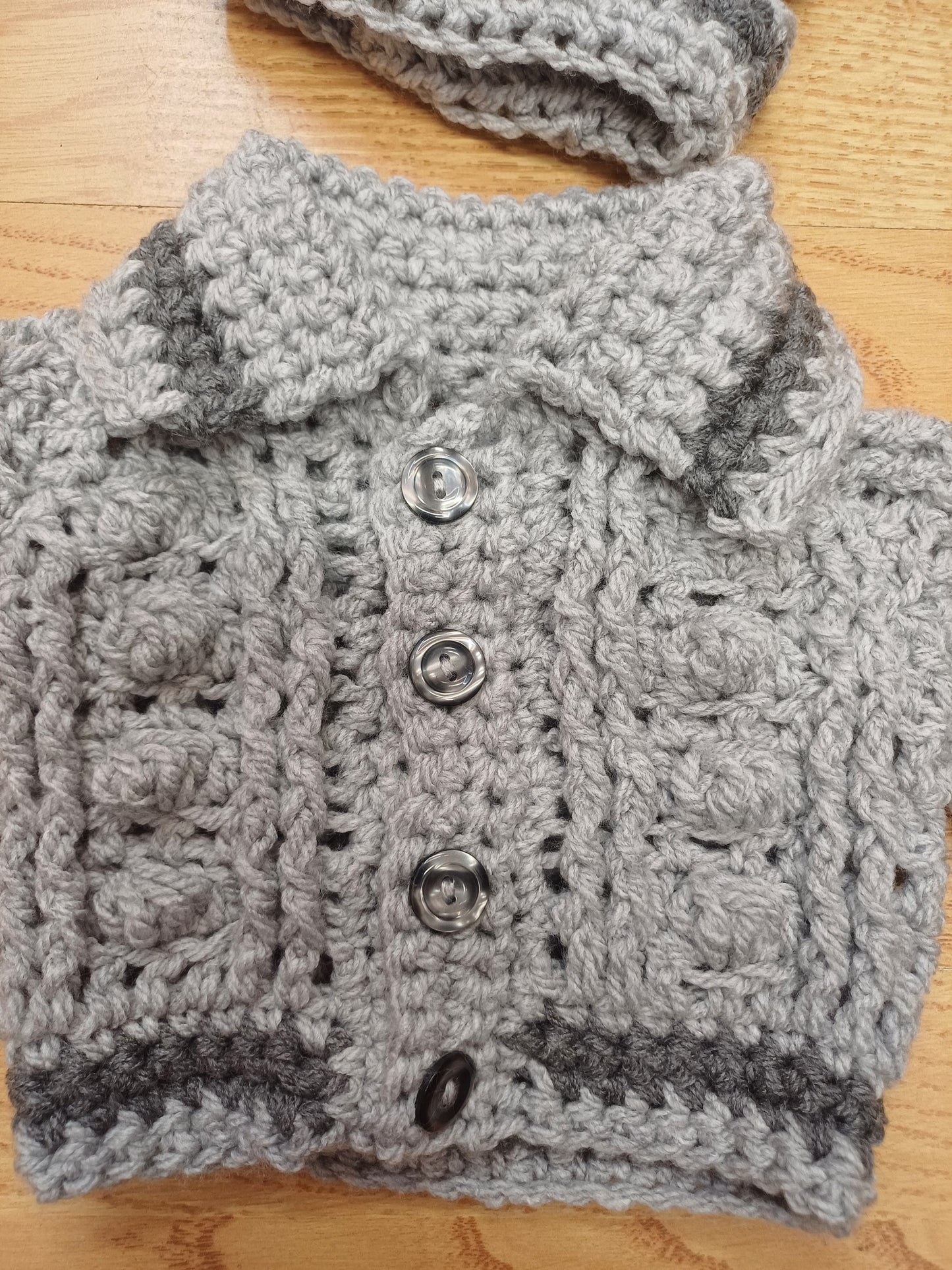Babys handmade crocheted cardigan and pom hat set