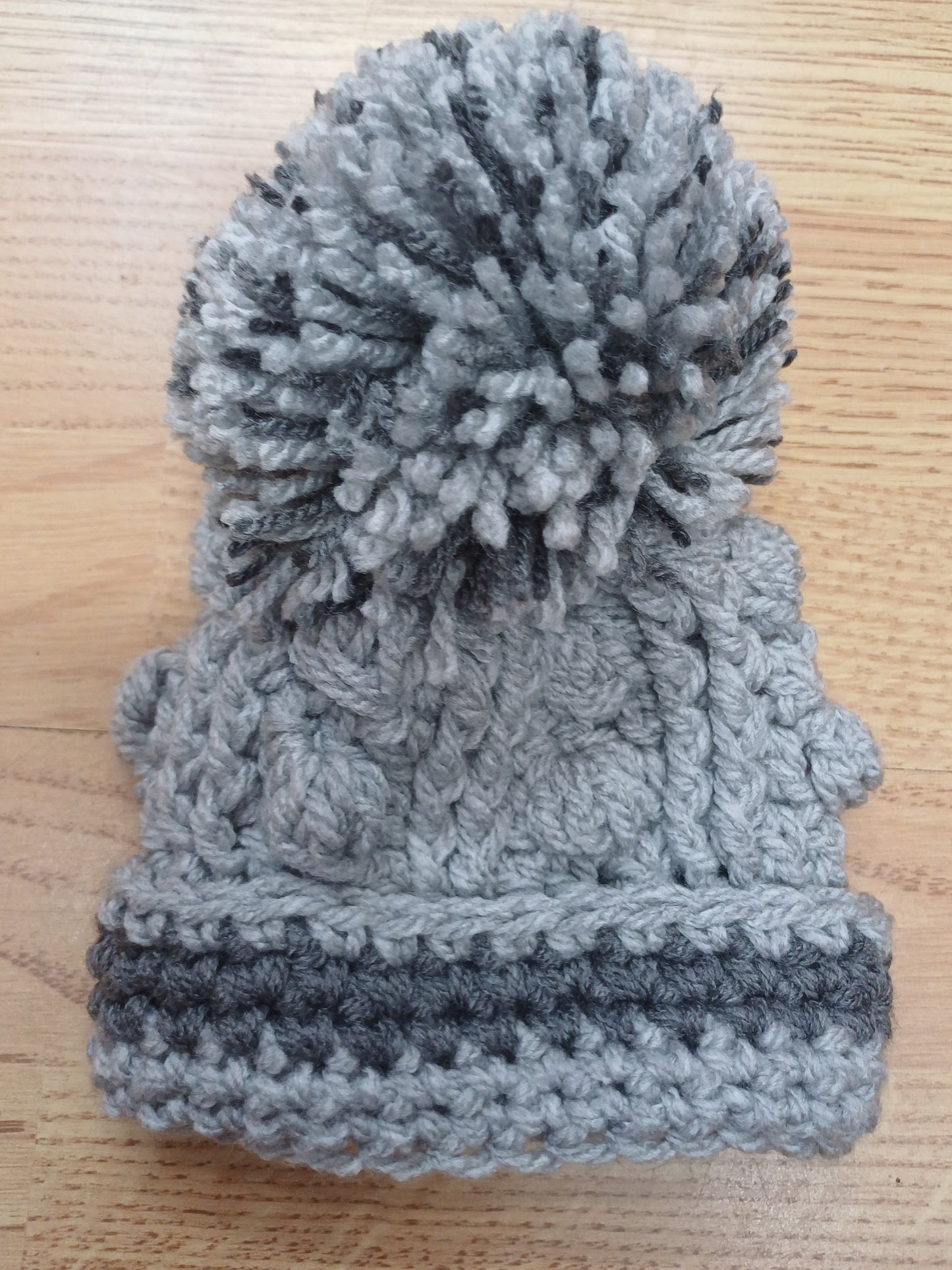 Babys handmade crocheted cardigan and pom hat set