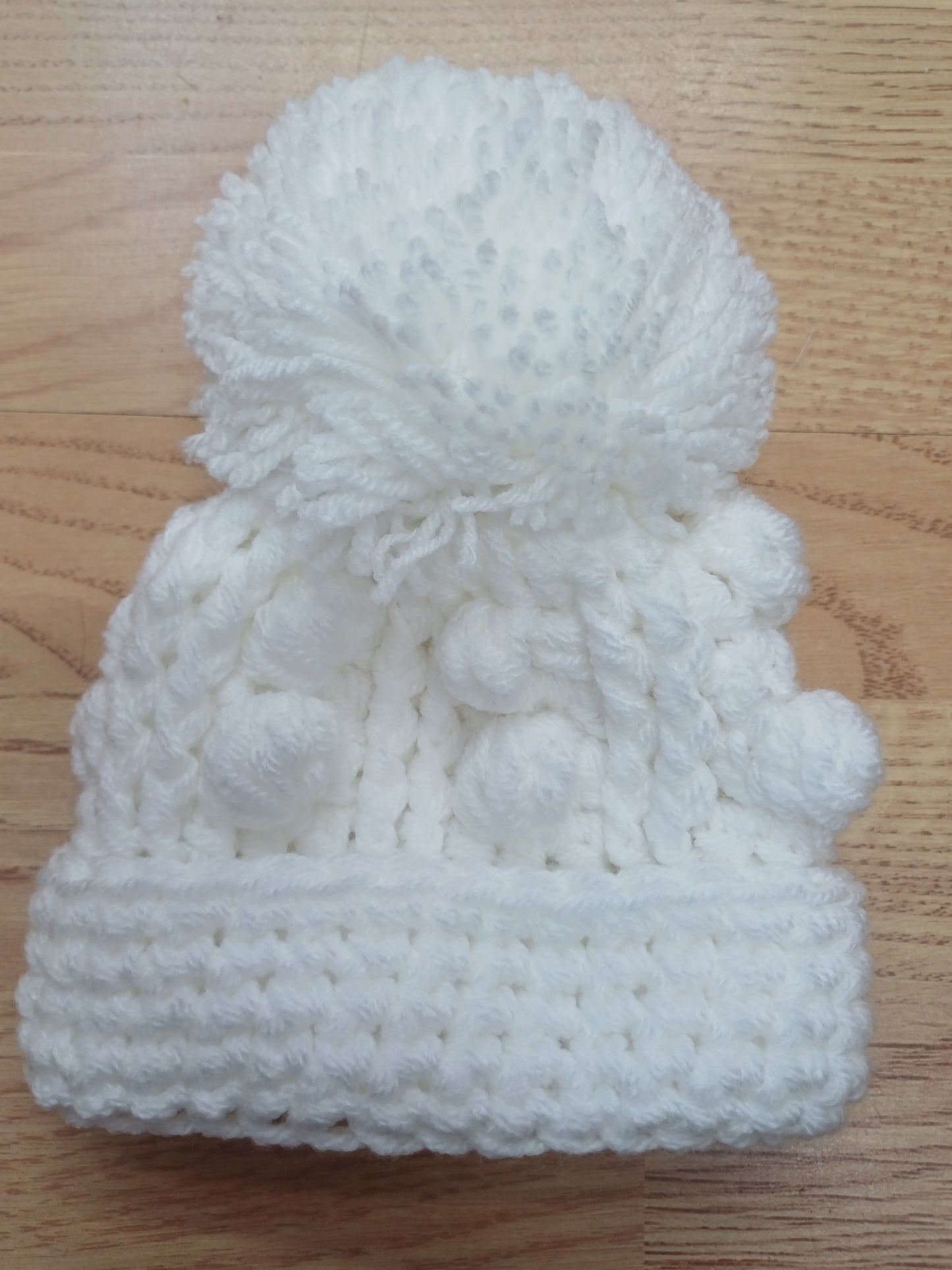 Babys handmade crocheted cardigan and pom hat set
