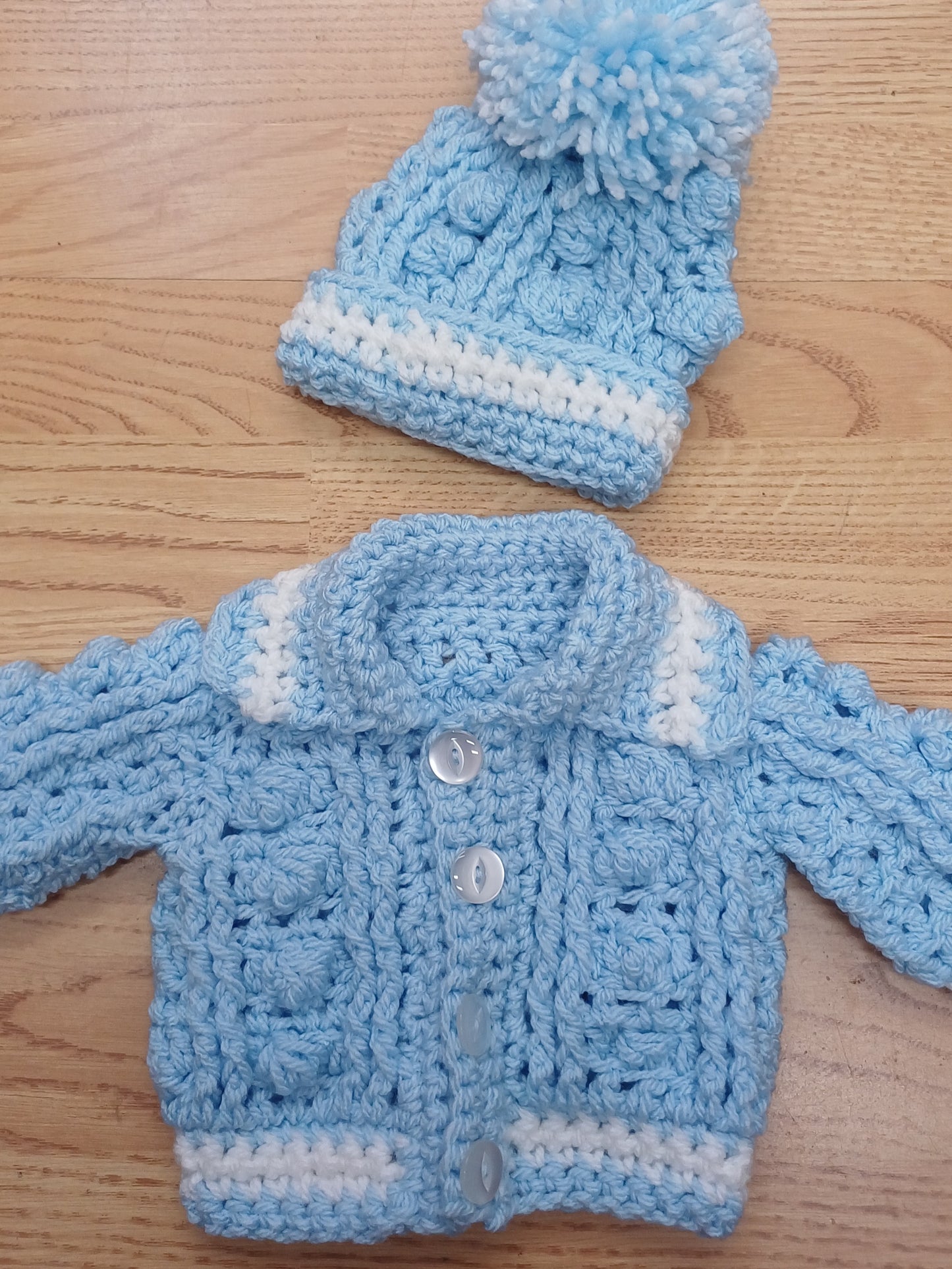 Babys handmade crocheted cardigan and pom hat set