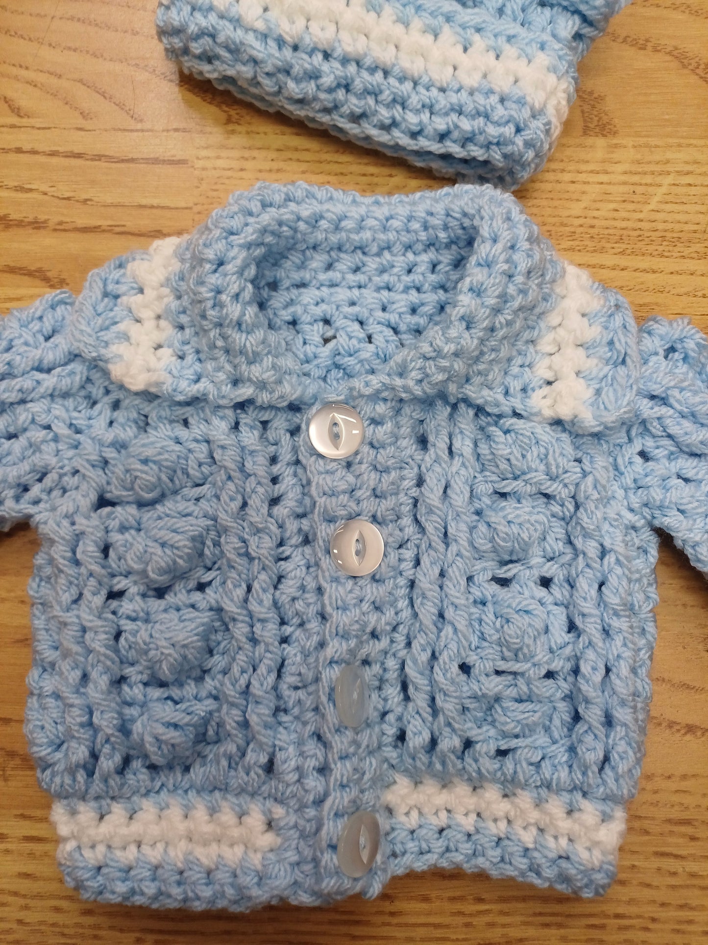 Babys handmade crocheted cardigan and pom hat set