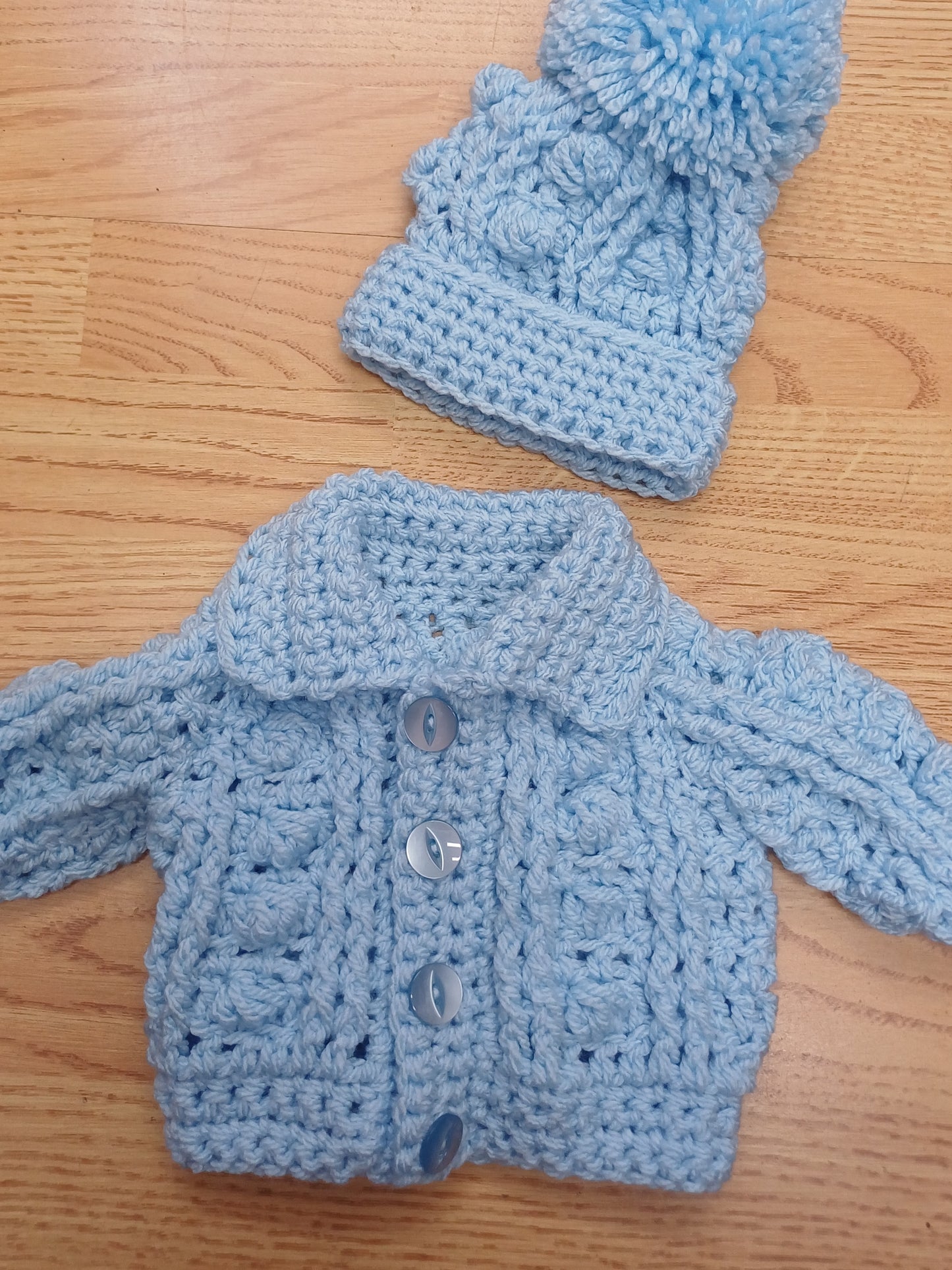 Babys handmade crocheted cardigan and pom hat set