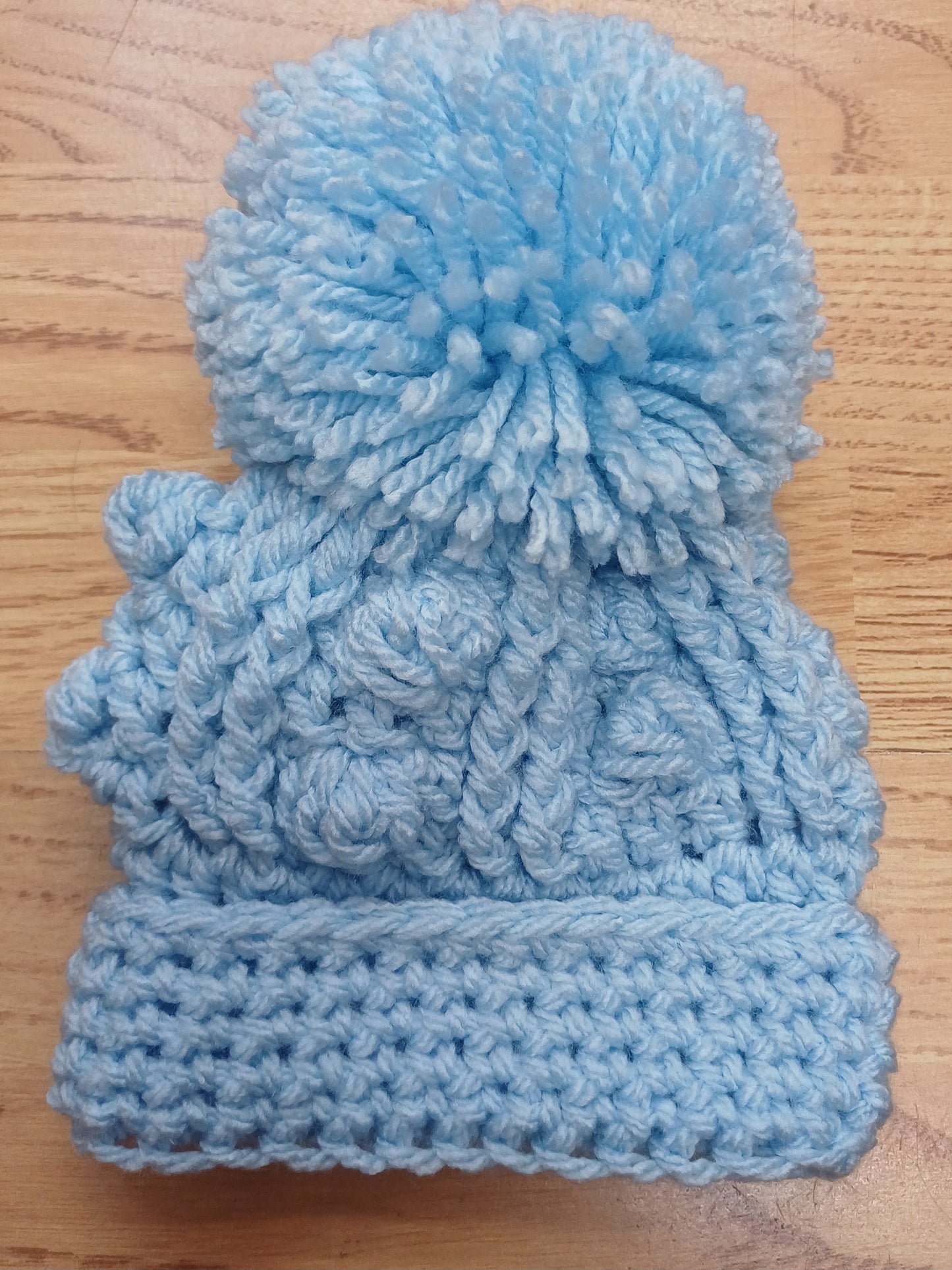 Babys handmade crocheted cardigan and pom hat set