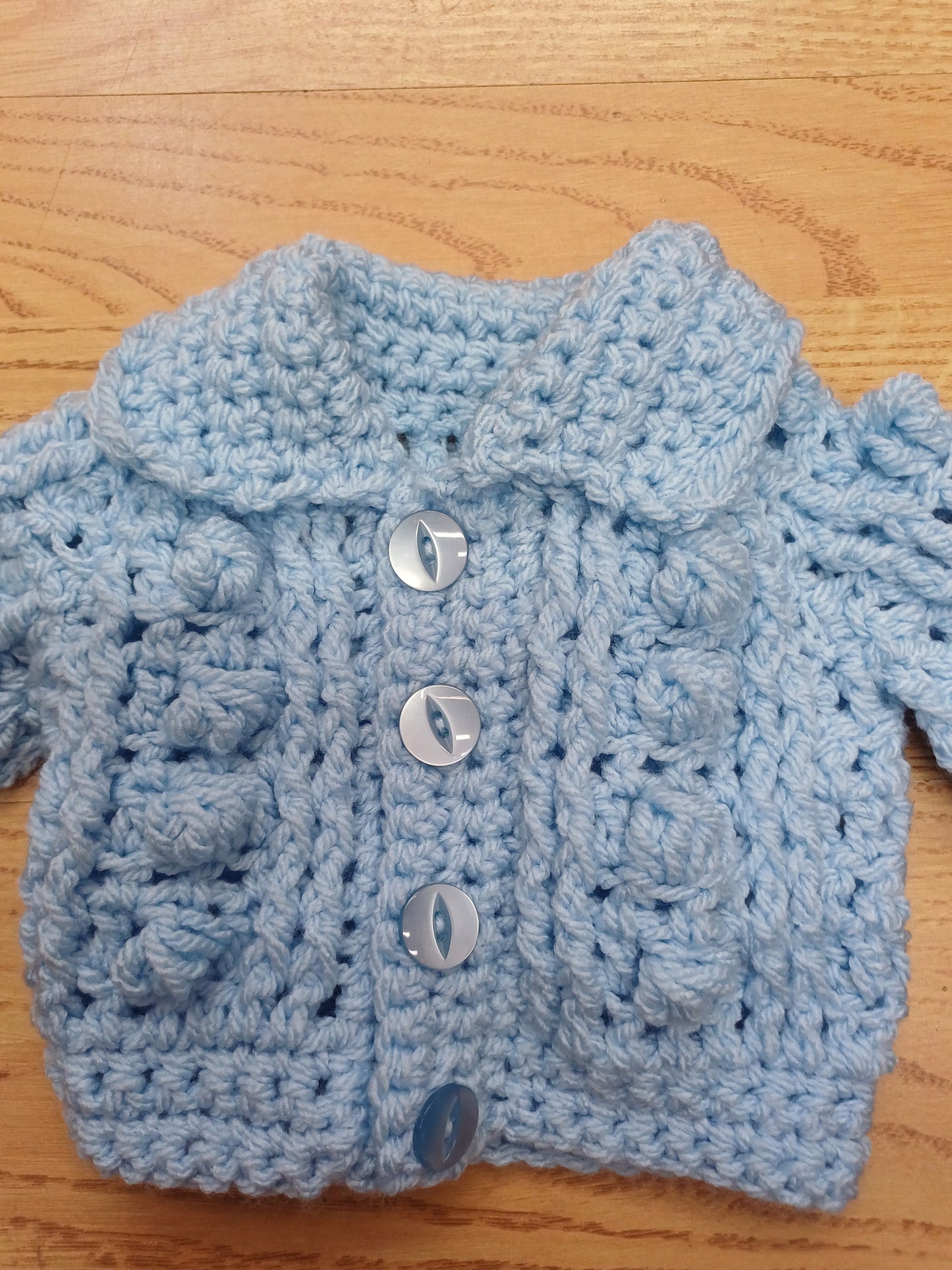Babys handmade crocheted cardigan and pom hat set