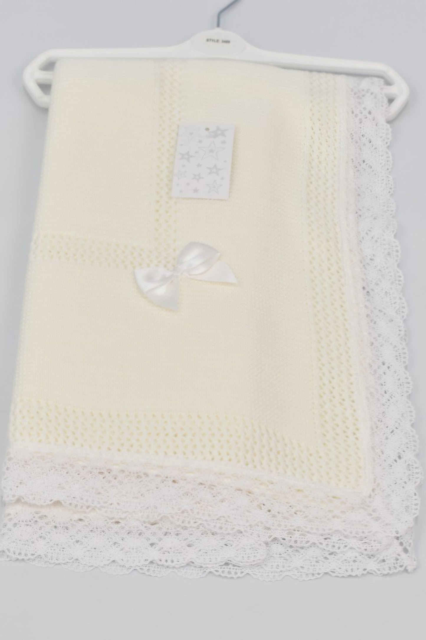 Babys white knitted ribbon blanket shawl with lace edge