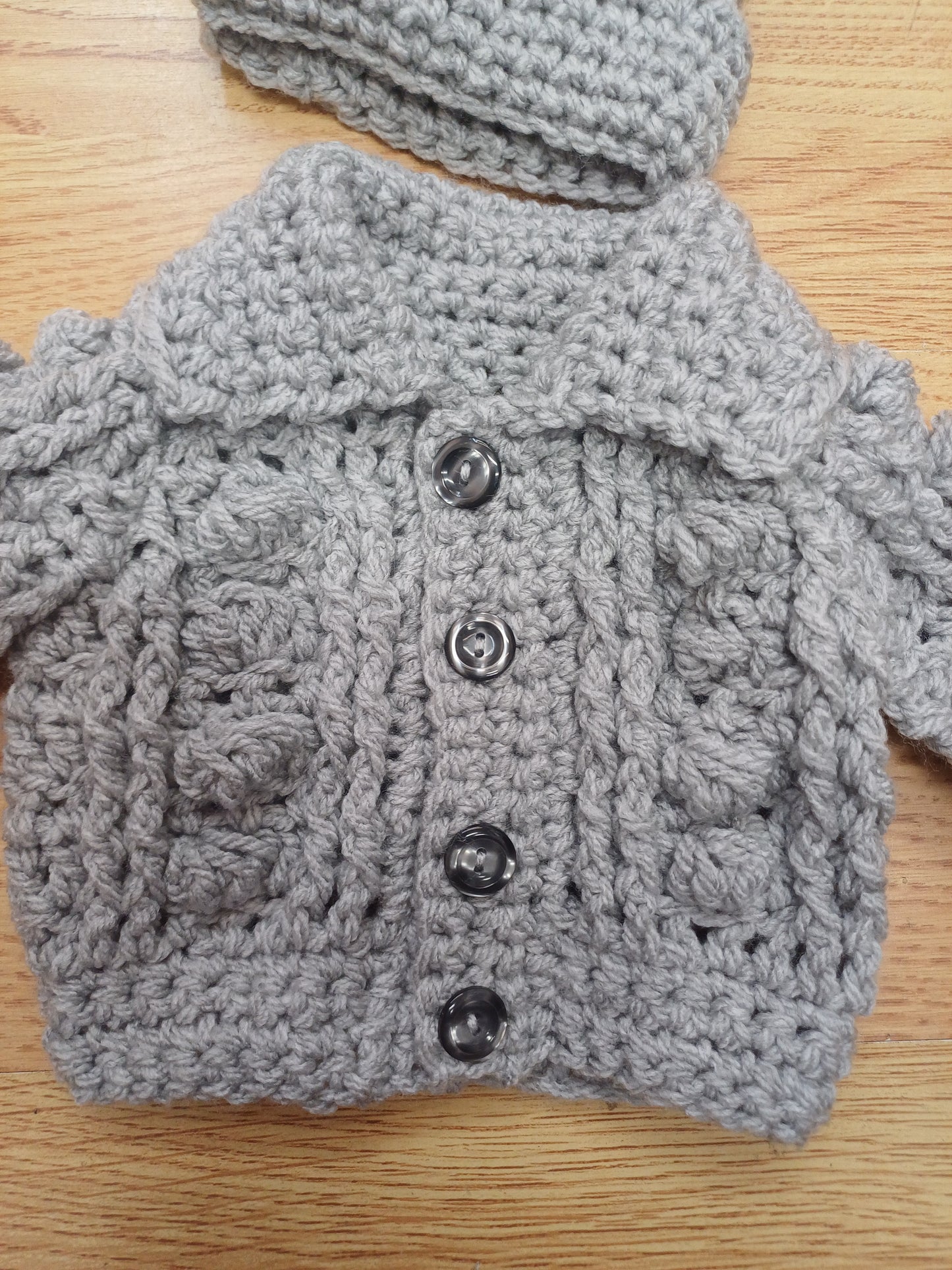 Babys handmade crocheted cardigan and pom hat set