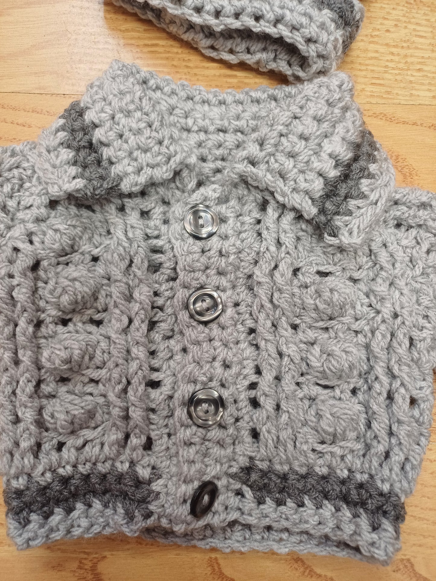 Babys  handmade crocheted cardigan and pom hat set