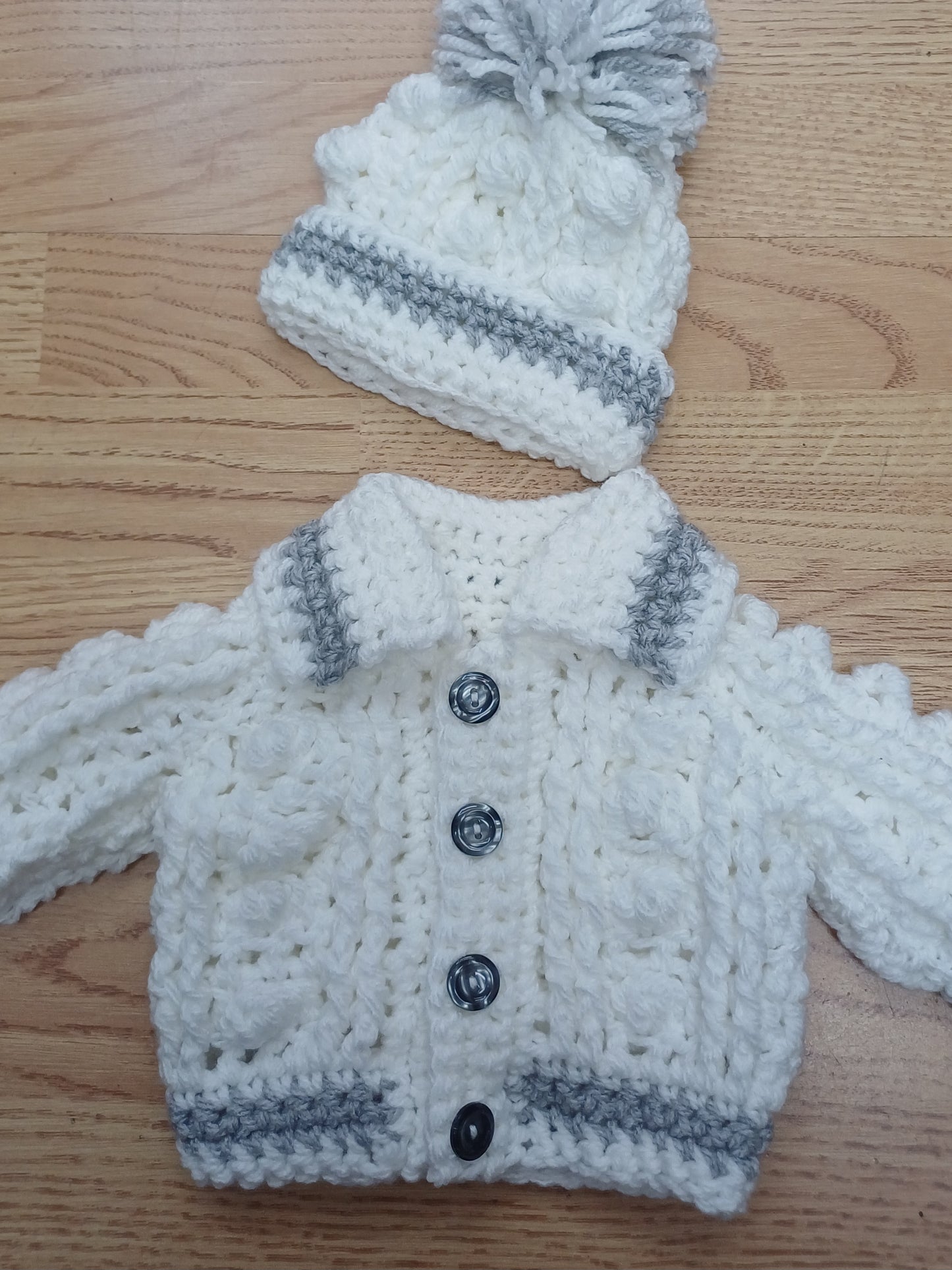 Babys handmade crocheted cardigan and pom hat set