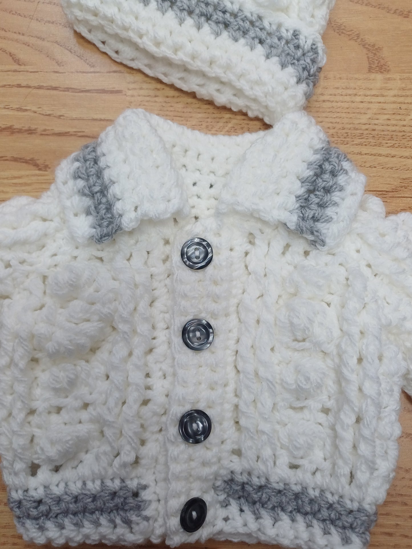 Babys handmade crocheted cardigan and pom hat set