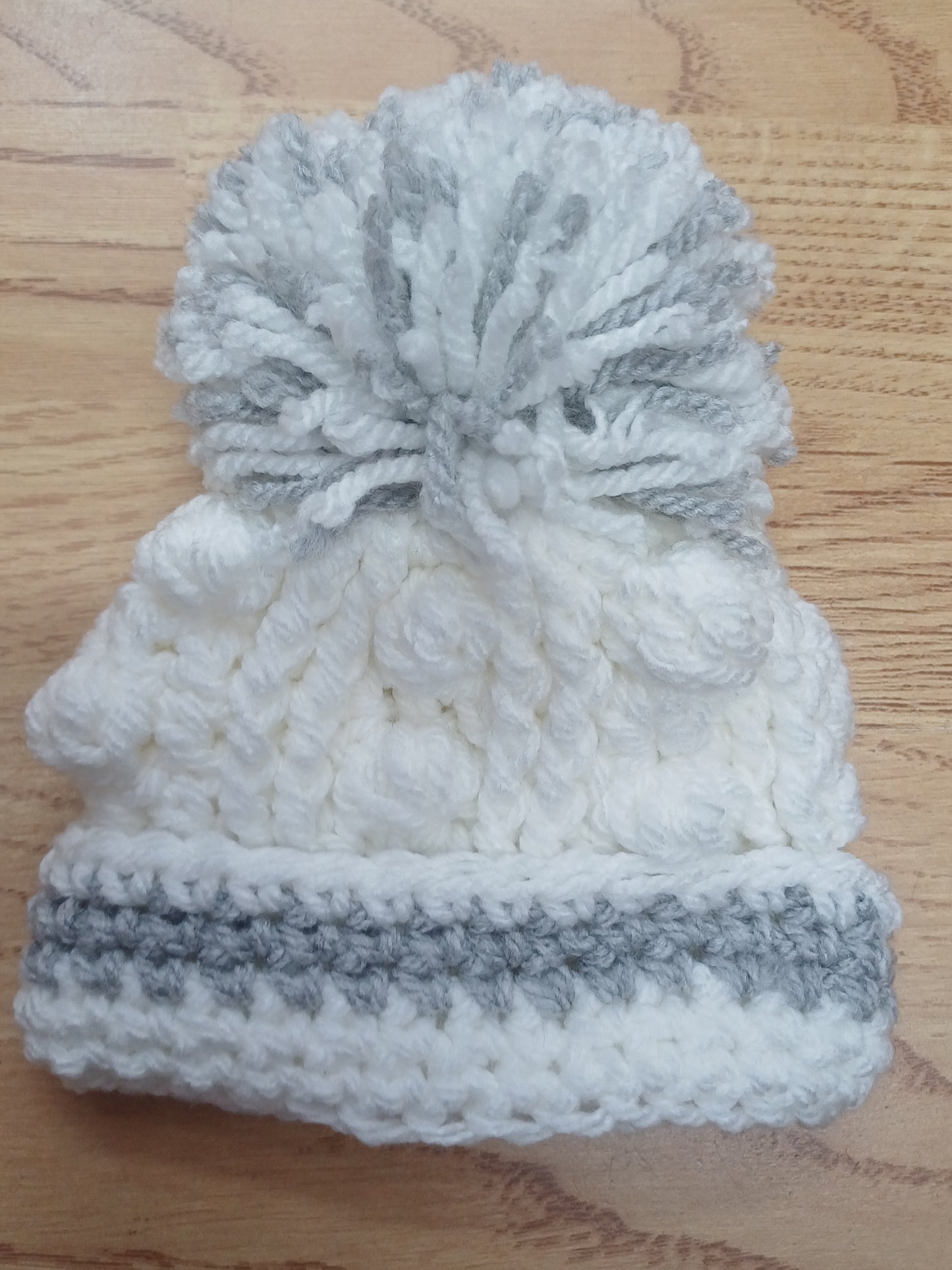 Babys handmade crocheted cardigan and pom hat set