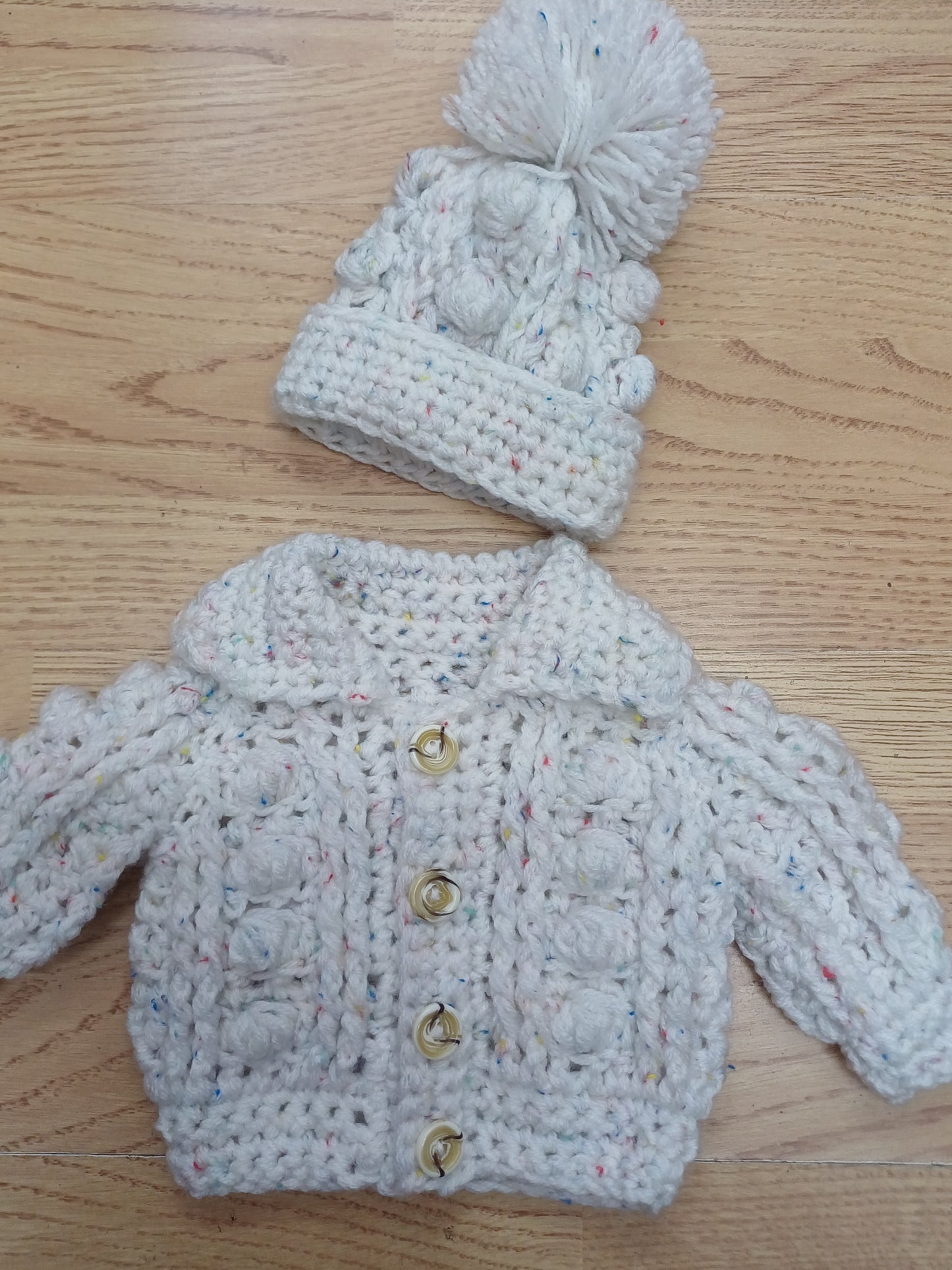 Babys handmade crocheted cardigan and pom hat set