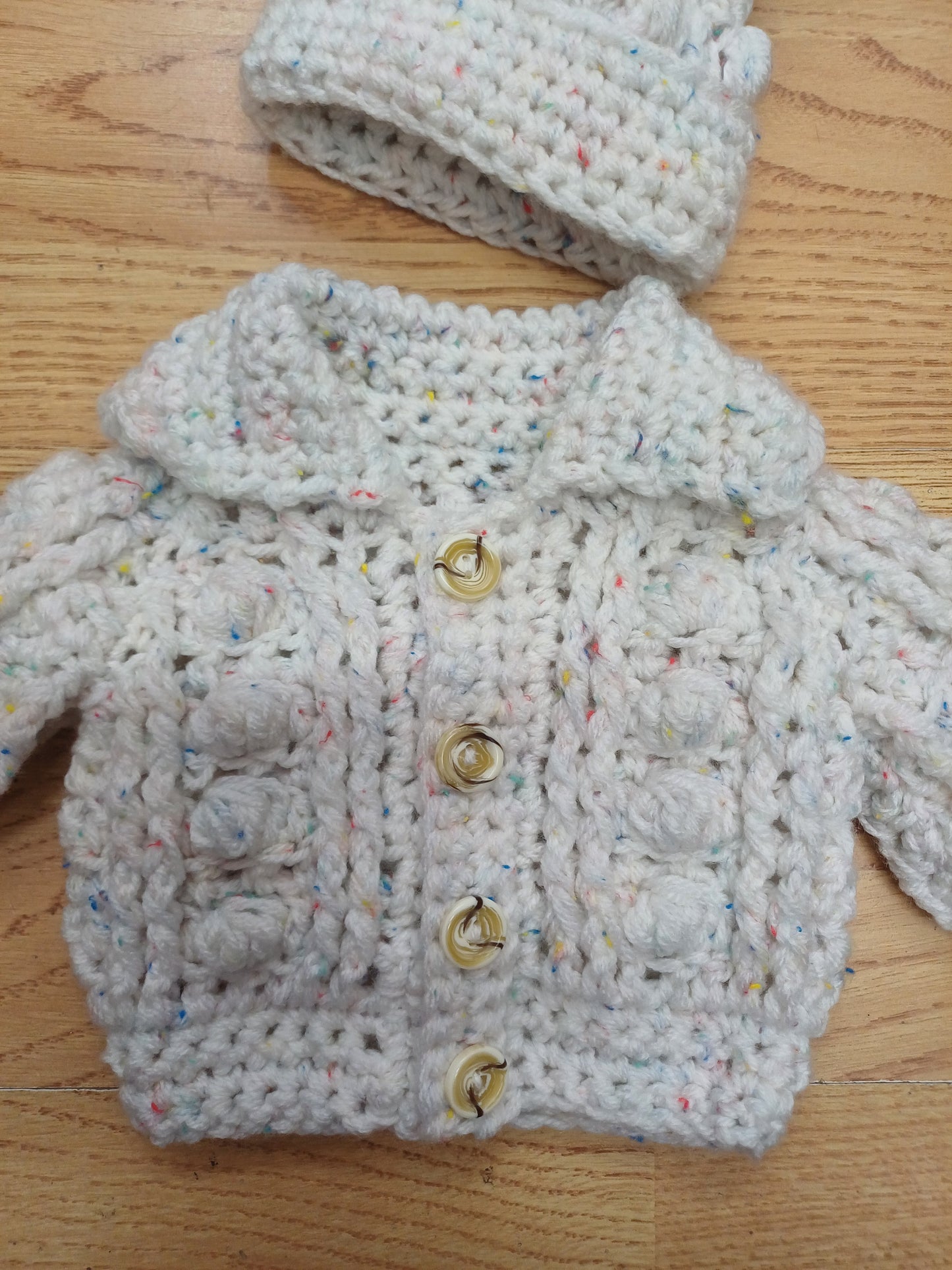 Babys handmade crocheted cardigan and pom hat set