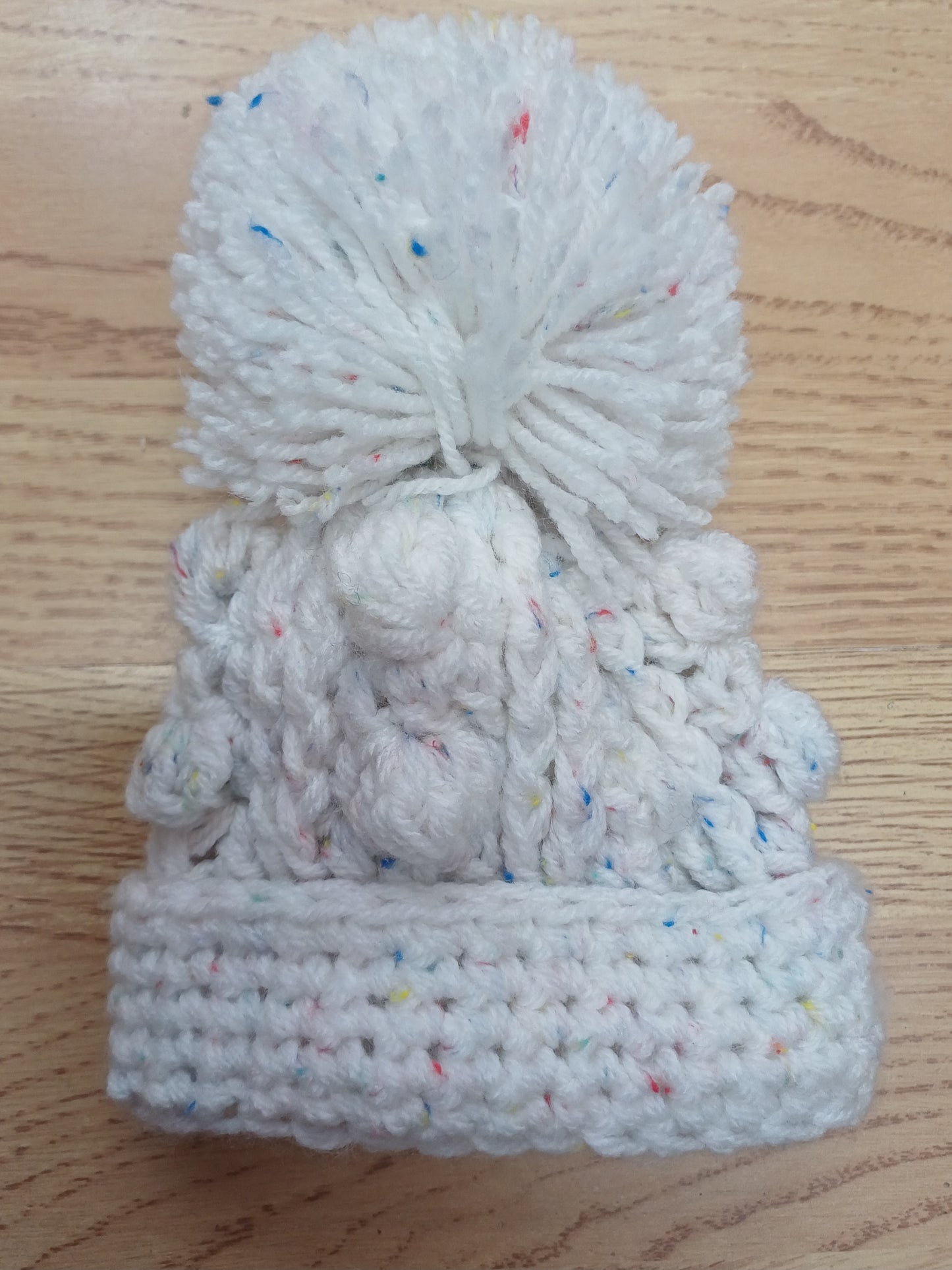 Babys handmade crocheted cardigan and pom hat set