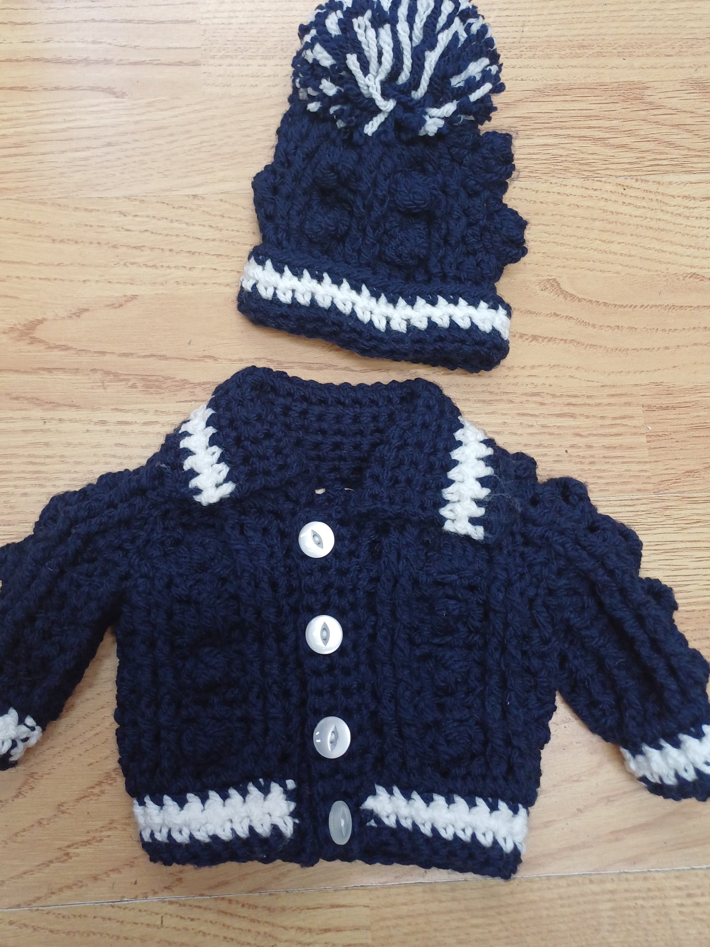 Babys handmade crocheted cardigan and pom hat set