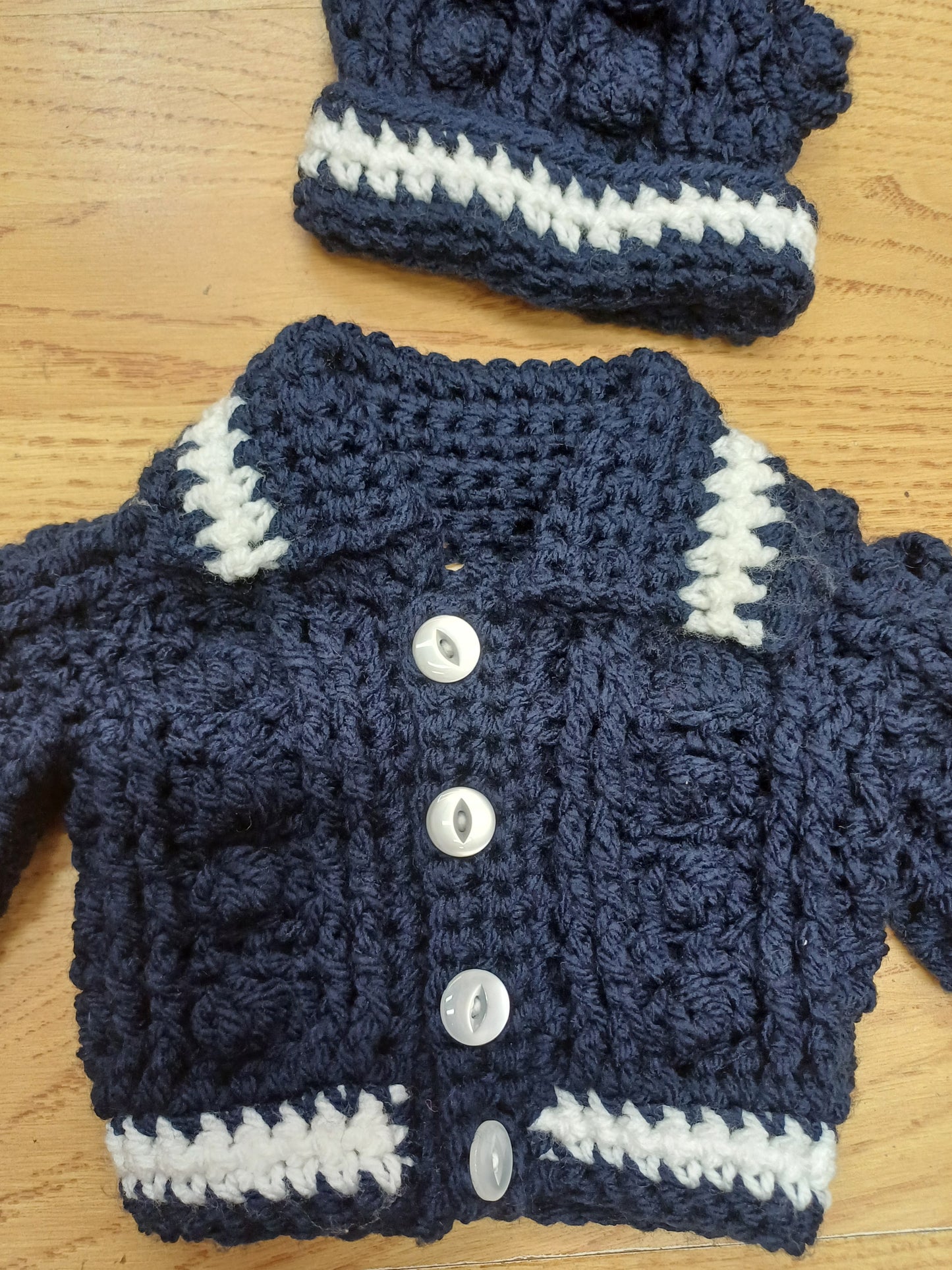 Babys handmade crocheted cardigan and pom hat set