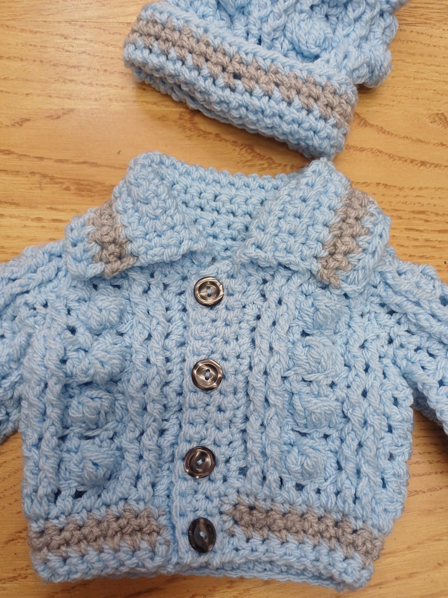 Babys handmade crocheted cardigan and pom hat set