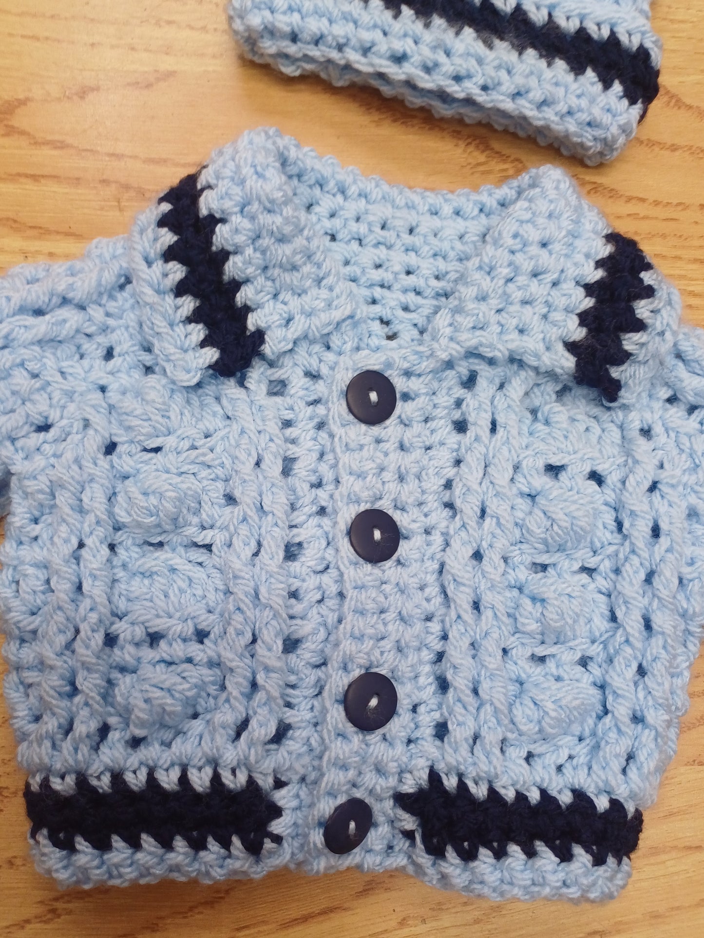 Babys handmade crocheted cardigan and pom hat set