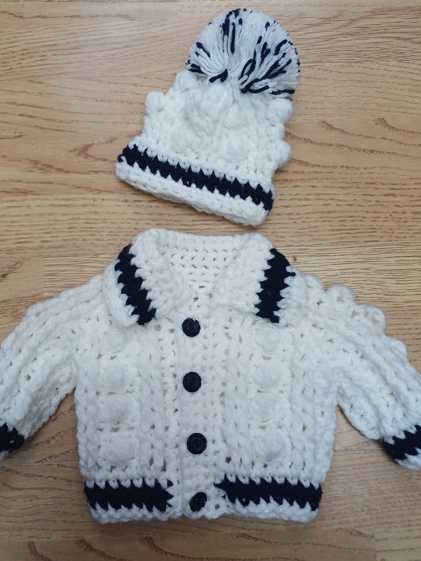 Babys handmade crocheted cardigan and pom hat set