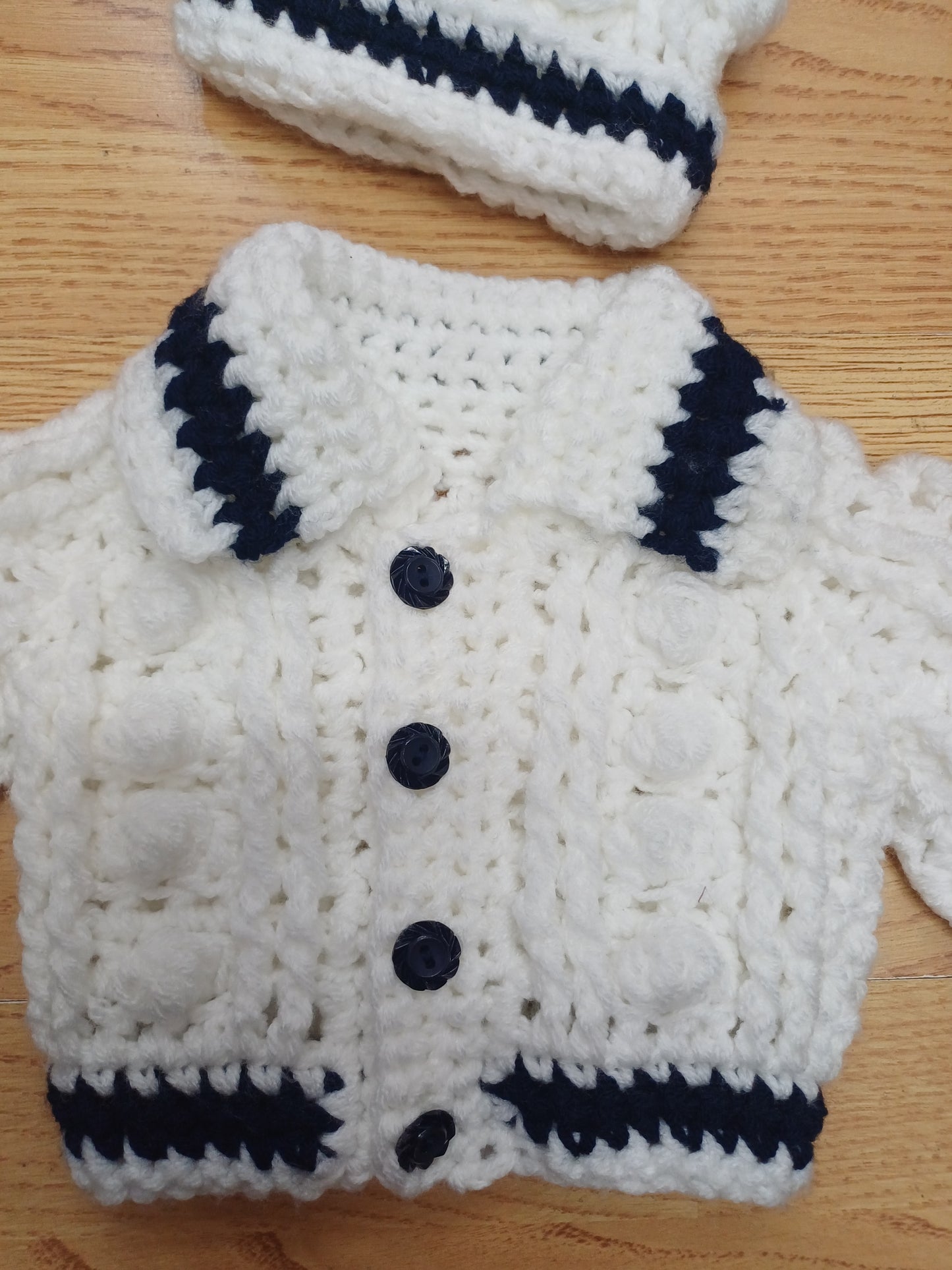 Babys handmade crocheted cardigan and pom hat set