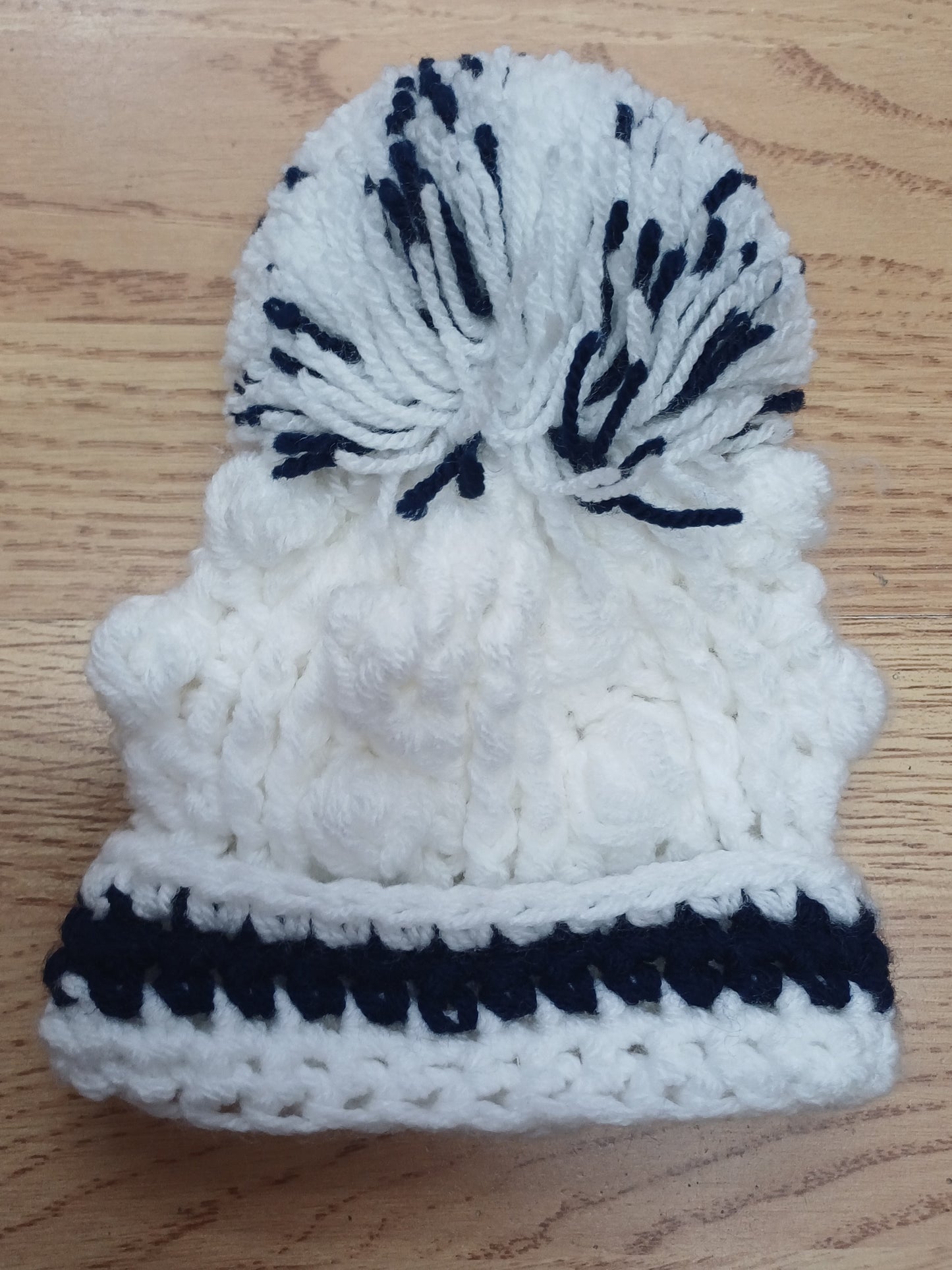 Babys handmade crocheted cardigan and pom hat set