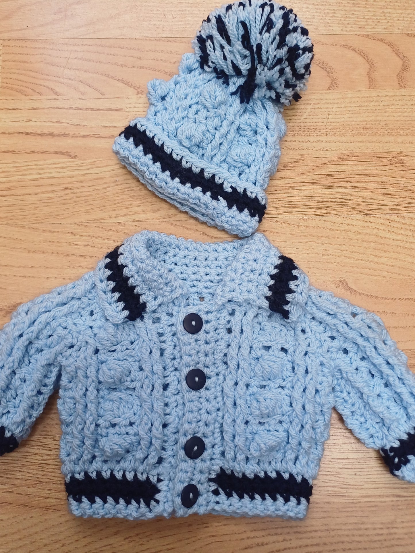 Babys handmade crocheted cardigan and pom hat set