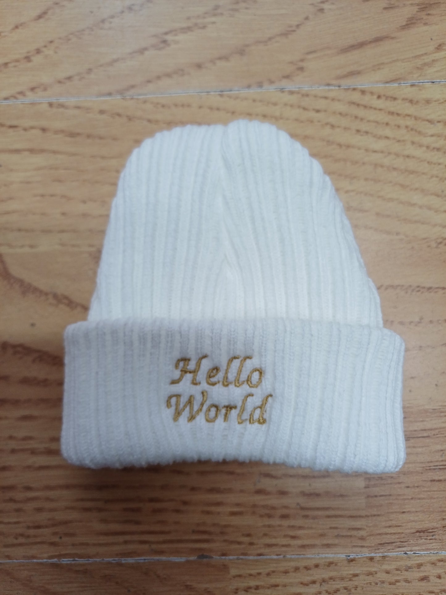 Babys  unisex knitted beanie hat embroidered with just arrived  or hello world size newborn