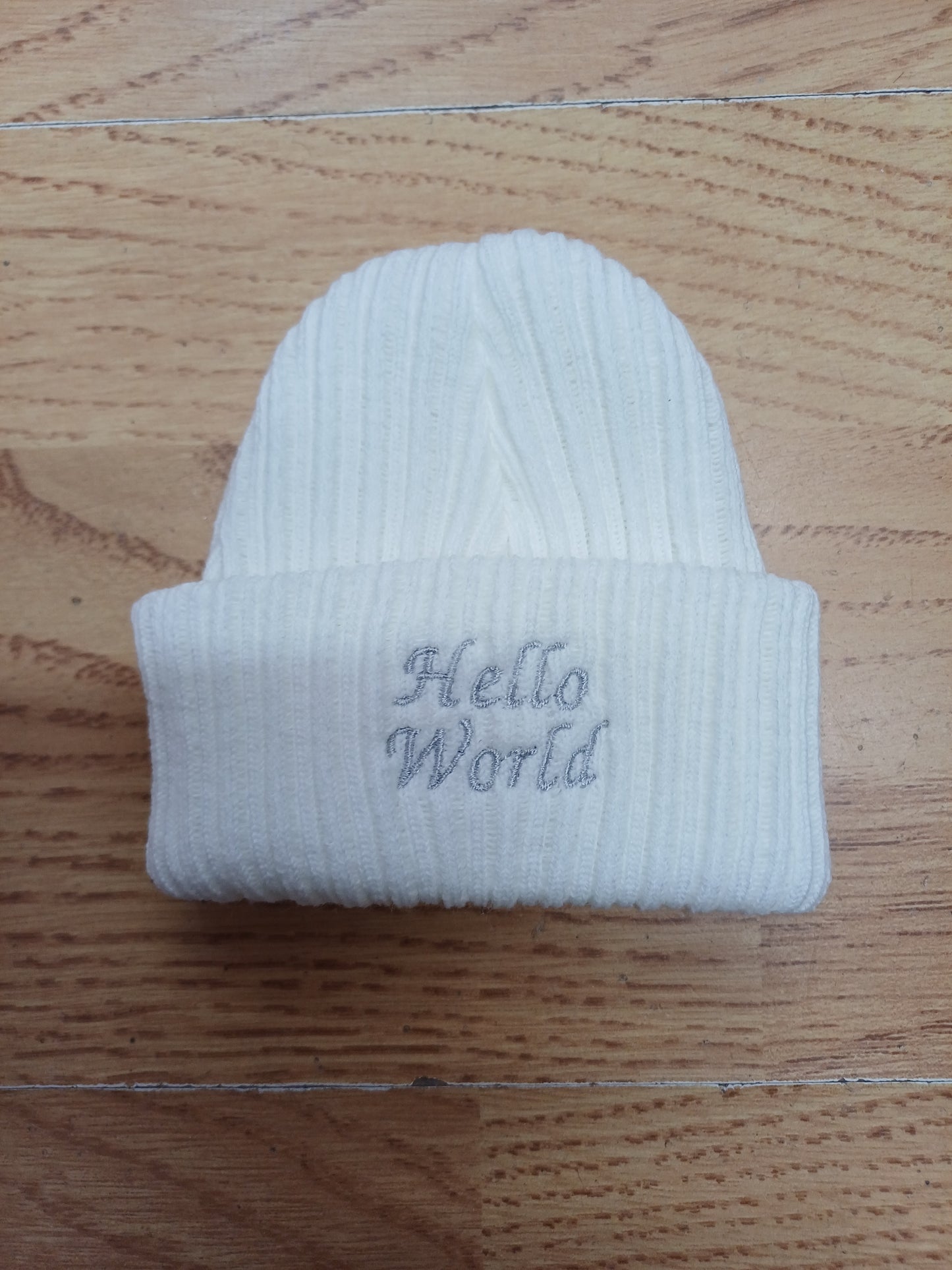 Babys  unisex knitted beanie hat embroidered with just arrived  or hello world size newborn