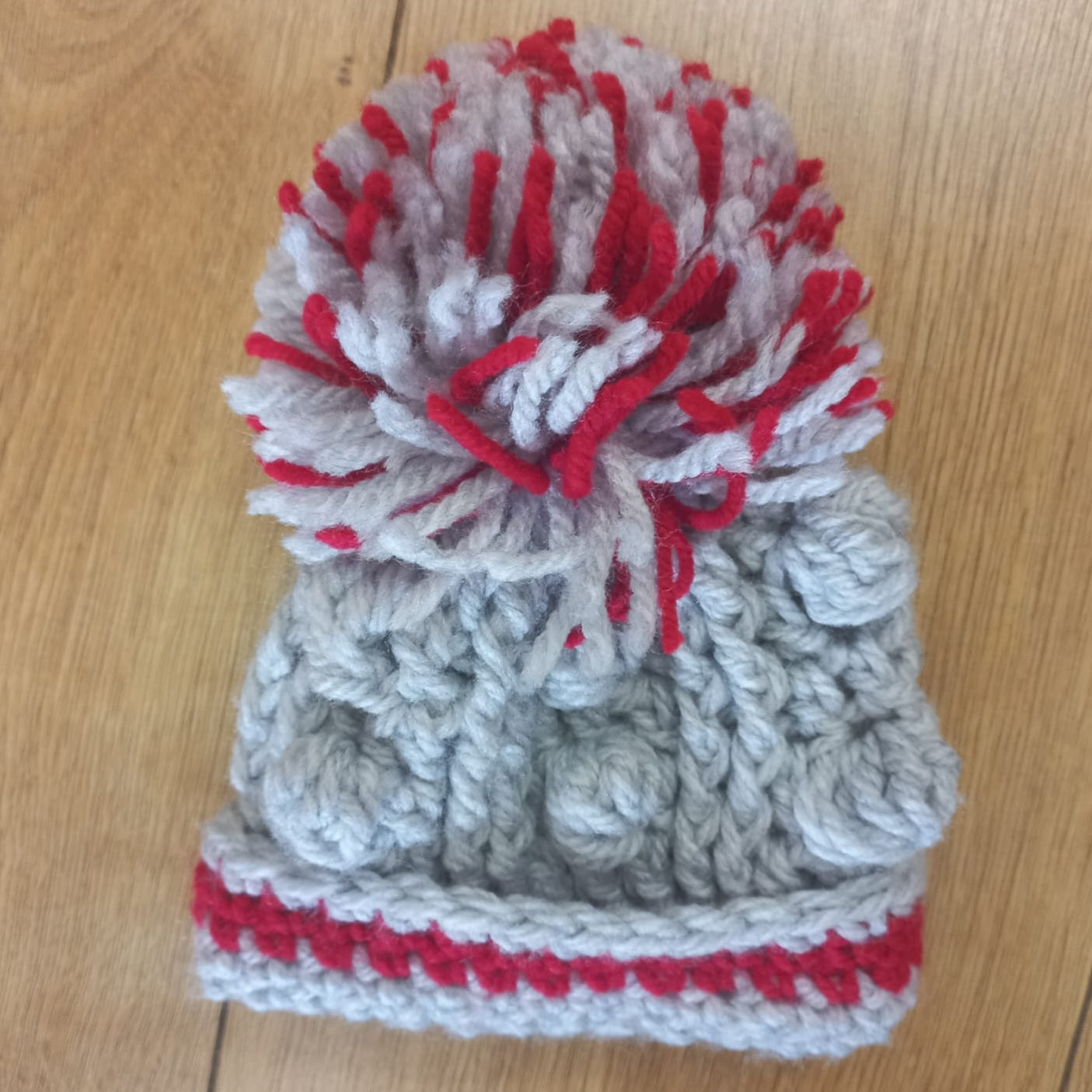 Babys handmade crocheted cardigan and pom hat set