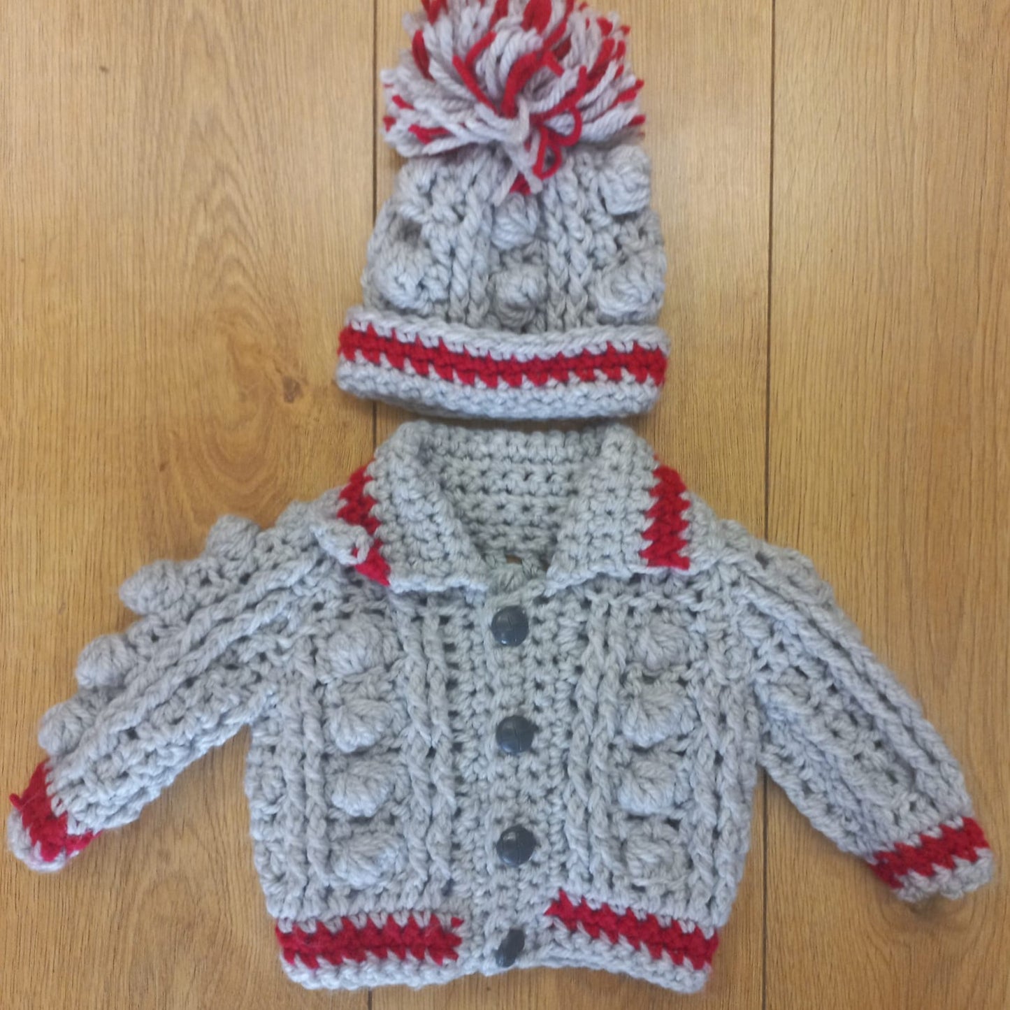 Babys handmade crocheted cardigan and pom hat set