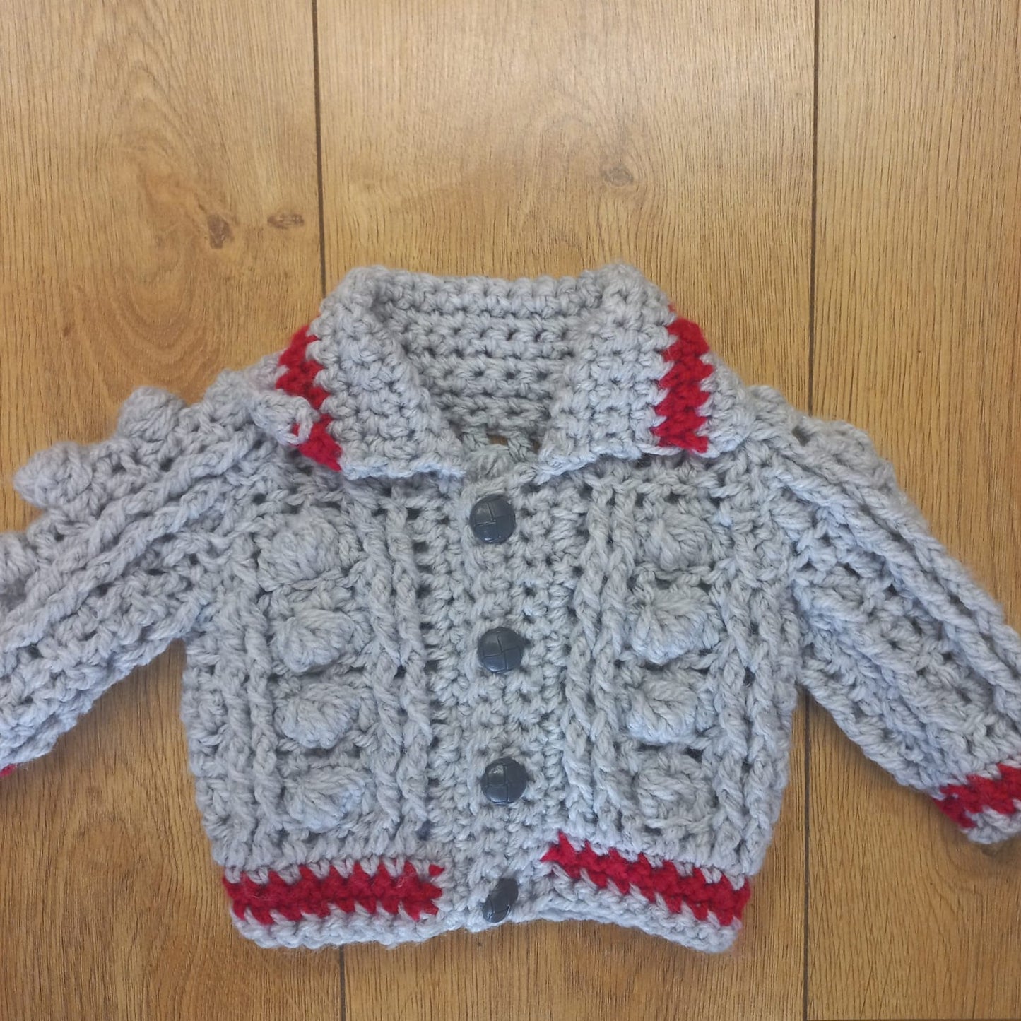 Babys handmade crocheted cardigan and pom hat set